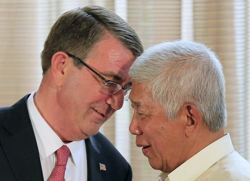 U.S. Defense Secretary Ash Carter, left, talks with his Philippine counterpart Voltaire Gazmin during their joint press conference at the Malacanang presidential palace in Manila, Philippines on Thursday, April 14, 2016. The United States on Thursday revealed for the first time that American ships have started conducting joint patrols with the Philippines in the South China Sea, a somewhat rare move not done with many other partners in the region. (Romeo Ranoco/Pool Photo via AP)