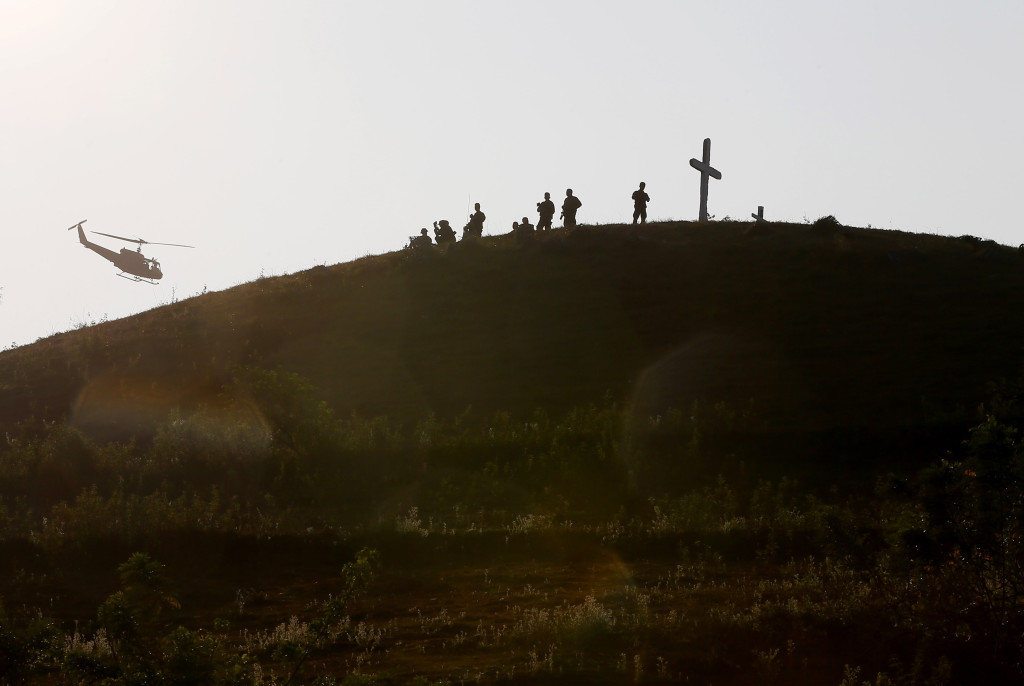 In this April 14, 2016, file photo, Philippine troops man their positions on top of a hill during joint U.S.-Philippines military exercises at Crow Valley, Philippines. With tensions rising in the South China Sea, The Pentagon said that nearly 300 American troops will remain in the Philippines through the end of the month following annual war games that ended Friday. (AP Photo/Bullit Marquez, File)