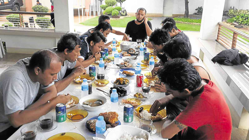 FREEDOM’S FULL MEAL Ten Indonesian sailors who were freed by the Abu Sayyaf eat a hearty meal of fried chicken, fish and rice at the house of Sulu Gov. Abdusakur Tan II in this photo he released to the Inquirer.
