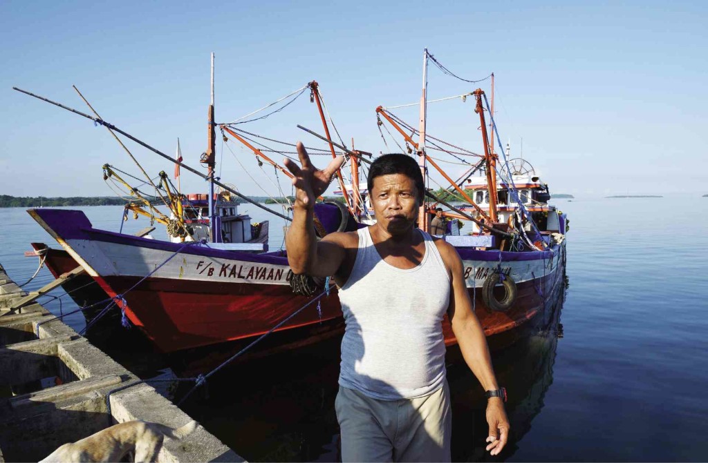 IDLED Epifanio Marqueza, one of the captains of a reef-fishing fleet, gestures next to his vessel idled in Masinloc, Zambales province, after an encounter with a Chinese Coast Guard ship at the nearby Panatag Shoal. AFP