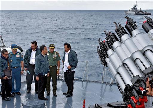 In this photo released by the Indonesian Presidential Office, Indonesian President Joko Widodo, third right, accompanied by, from left to right, Cabinet Secretary Pramono Anung, Navy Chief of Staff, Adm. Ade Supandi, top security minister Luhut Panjaitan, Armed Forces Chief Gen. Gatot Nurmantyo and Riau Islands Governor Nurdin Basirun stands on the deck of navy warship KRI Imam Bonjol, on the waters of Natuna Islands, Indonesia, Thursday, June 23, 2016. AP