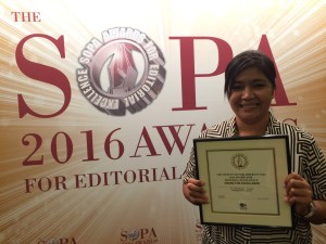 Inquirer photographer Marianne Bermudez shows off the Award for Excellence in News Photography granted by the Society of Publishers in Asia (SOPA) on Wednesday night, June 15, 2016, in Hong Kong