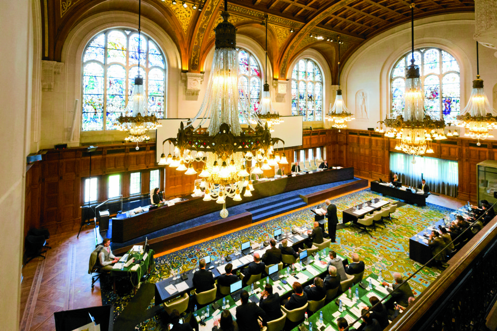 In this July 7, 2015, image provided by the Permanent Court of Arbitration, the case regarding the Philippines and China on the South China Sea is heard at the Permanent Court of Arbitration (PCA) at The Hague, the Netherlands.  An arbitration panel in The Hague, Netherlands, will issue a ruling Tuesday, July 12, 2016, in a long-running dispute between the Philippines and China over the South China Sea. The Philippines has asked the tribunal to declare China's claims and actions invalid under the U.N. Convention on the Law of the Sea. Beijing has refused to join the case, rejecting the tribunal's jurisdiction, and says it will not accept the decision.(Permanent Court of Arbitration via AP) 