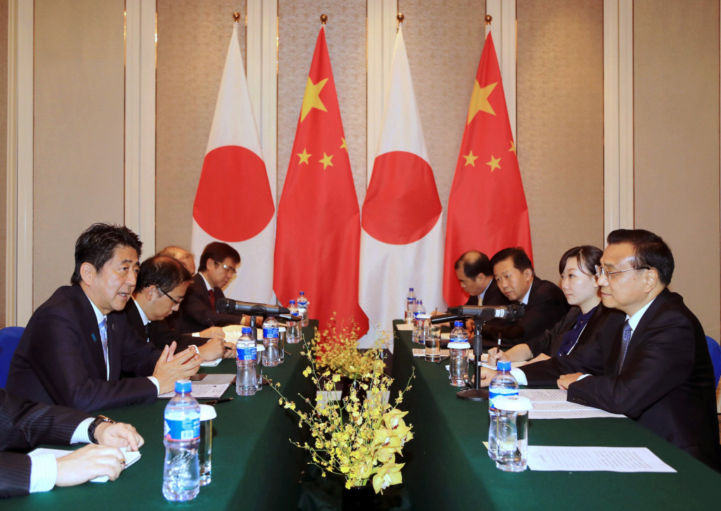 Japanese Prime Minister Shinzo Abe, left, speaks to Chinese Premier Li Keqiang, right, during a bilateral meeting held on the sideline of the 11th Asia-Europe Meeting (ASEM) Summit in Ulaanbaatar, Mongolia, Friday, July 15, 2016. (Kyodo News via AP) JAPAN OUT, CREDIT MANDATORY