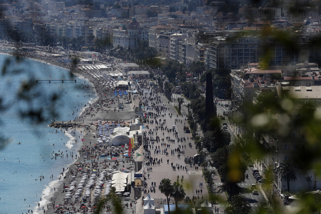 View of the famed Promenade des Anglais scene of the Thursday's attack in Nice, southern France, Sunday, July 17, 2016 three days after a truck mowed through revelers. French authorities detained two more people Sunday in the investigation into the Bastille Day truck attack on the Mediterranean city of Nice that killed at least 84 people, as authorities try to determine whether the slain attacker was a committed religious extremist or just a very angry man.(AP Photo/Francois Mori)