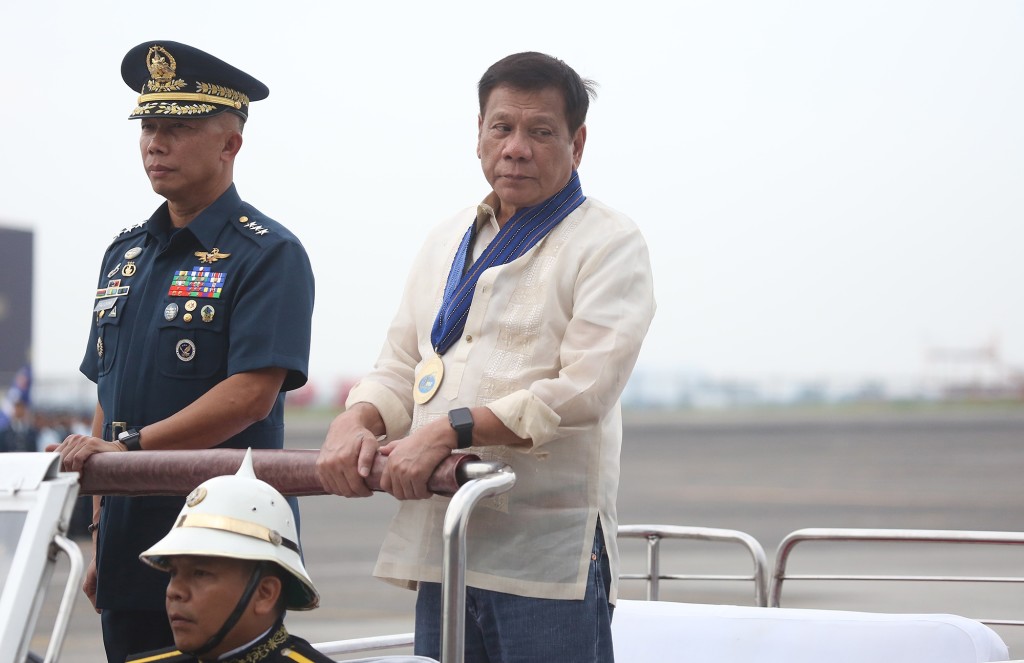GROOVY PRESIDENT DUTERTE / JULY 5,2016 President Rodrigo Duterte in wears a maong pants and folded sleeves of barong  inspects the troops  during the 69th founding anniversary of the Philippine ?Airforce held in Clark airbase, pampanga. INQUIRER PHOTO/JOAN BONDOC