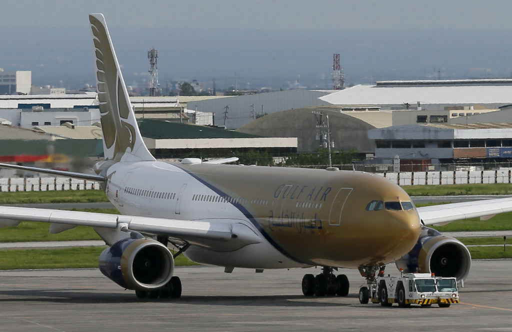 A Gulf Air passenger plane is towed by ground crew for inspection after it made an emergency landing about 25 minutes into the flight Friday, Aug. 5, 2016, at the Ninoy Aquino International Airport at suburban Pasay city south of Manila, Philippines. TThe Gulf Air flight, carrying 219 people on a flight to Bahrain made an emergency landing in the Philippines, returning there Friday after the pilot reported intense heat in the left engine of the Airbus 330-200 shortly after take-off, and smoke was seen in the cabin, airport officials said. Ma. .(AP Photo/Bullit Marquez)