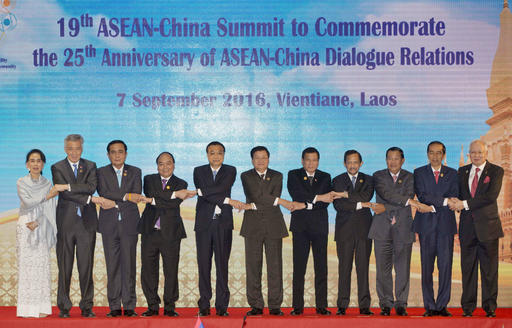 China's Premier Li Keqiang, fifth from left, links hands with leaders of the Association of Southeast Asian Nations (ASEAN) during 19th ASEAN-China summit, a parallel summit in the ongoing 28th and 29th ASEAN Summits at National Convention Center in Vientiane, Laos, Wednesday, Sept. 7, 2016. ASEAN leaders from left; Myanmar's Foreign Minister Aung San Suu Kyi, Singapore's Prime Minister Lee Hsien Loong, Thailand's Prime Minister Prayuth Chan-ocha, Vietnam's Prime Minister Nguyen Xuan Phuc, Laos' Prime Minister Thongloun Sisoulith, Philippines' President Rodrigo Duterte, Brunei's Foreign Minister and Prime Minister Sultan Hassanal Bolkiah, Cambodia's Prime Minister Hun Sen, Indonesia's President Joko Widodo, and Malaysia's Prime Minister Najib Razak.(AP Photo/Gemunu Amarasinghe)