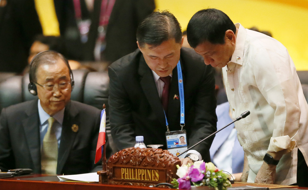 U.N. Secretary General Ban Ki-moon, left, glances at Philippine President Rodrigo Duterte, right, at the start of 11th East Asia Summit on the last day of the 28th and 29th ASEAN Summits and other related summits at the National Convention Center Thursday, Sept. 8, 2016 in Vientiane, Laos. (AP Photo/Bullit Marquez)