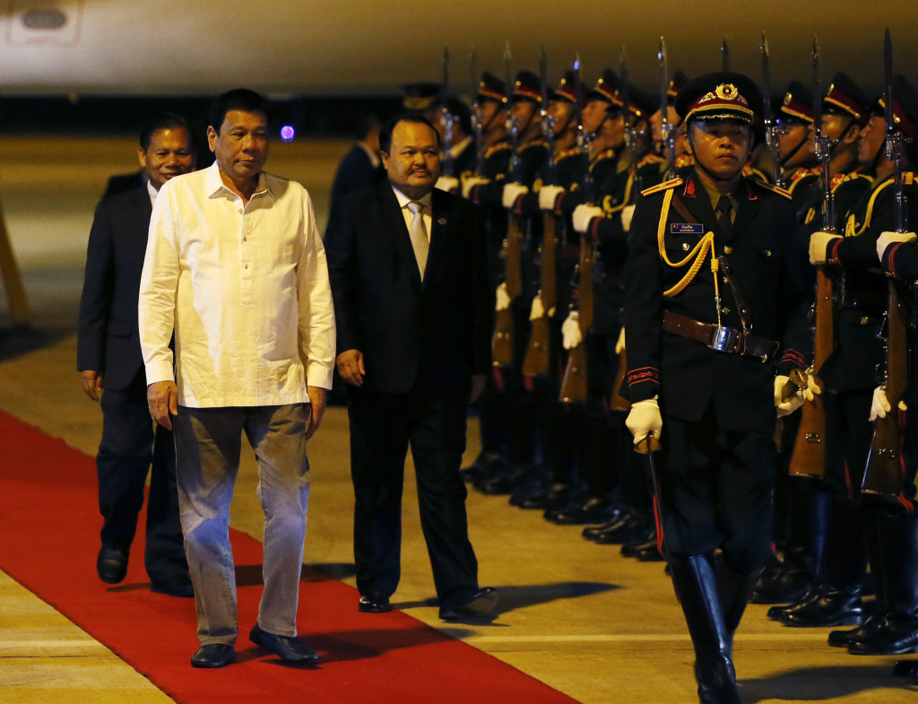 Philippine President Rodrigo Duterte reviews the troops upon arrival in Vientiane, Laos to attend the 28th and 29th ASEAN Summits and other related summits Monday, Sept. 5, 2016 in Vientiane, Laos. Laos is this year's host of the annual regional meeting and its dialogue partners that includes the United States, Canada, Russia, Japan, China, South Korea, Australia, New Zealand and India.(AP Photo/Bullit Marquez)
