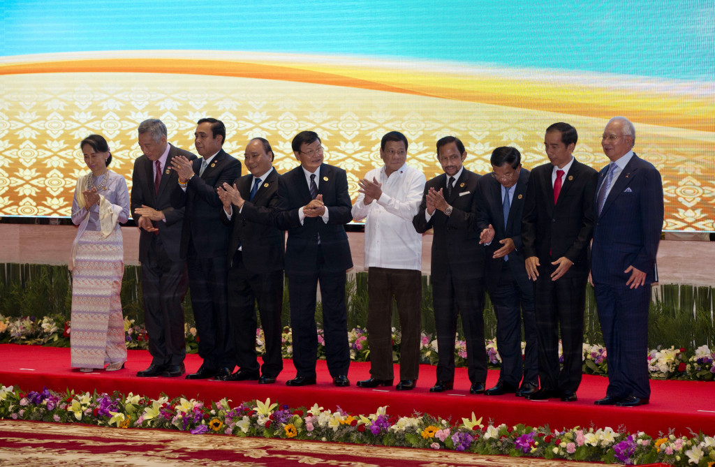 Leaders of the Association of Southeast Asian Nations (ASEAN) applaud after posing for a group photo at National Convention Center in Vientiane, Laos, Tuesday, Sept. 6, 2016. Leaders from left, Myanmar's State Counsellor and Foreign Minister Aung San Suu Kyi, Singapore's Prime Minister Lee Hsien Loong, Thai Prime Minister Prayuth Chan-ocha, Vietnam's President Tran Dai Quang, Laos Prime Minister Thongloun Sisoulith, Philippine's President Rodrigo Duterte, Brunei Foreign Minister and Prime Minister Sultan Hassanal Bolkiah, Cambodian Prime Minister Hun Sen, Indonesia's President Joko Widodo and Malaysia's Prime Minister Najib Razak. (AP Photo/Gemunu Amarasinghe)