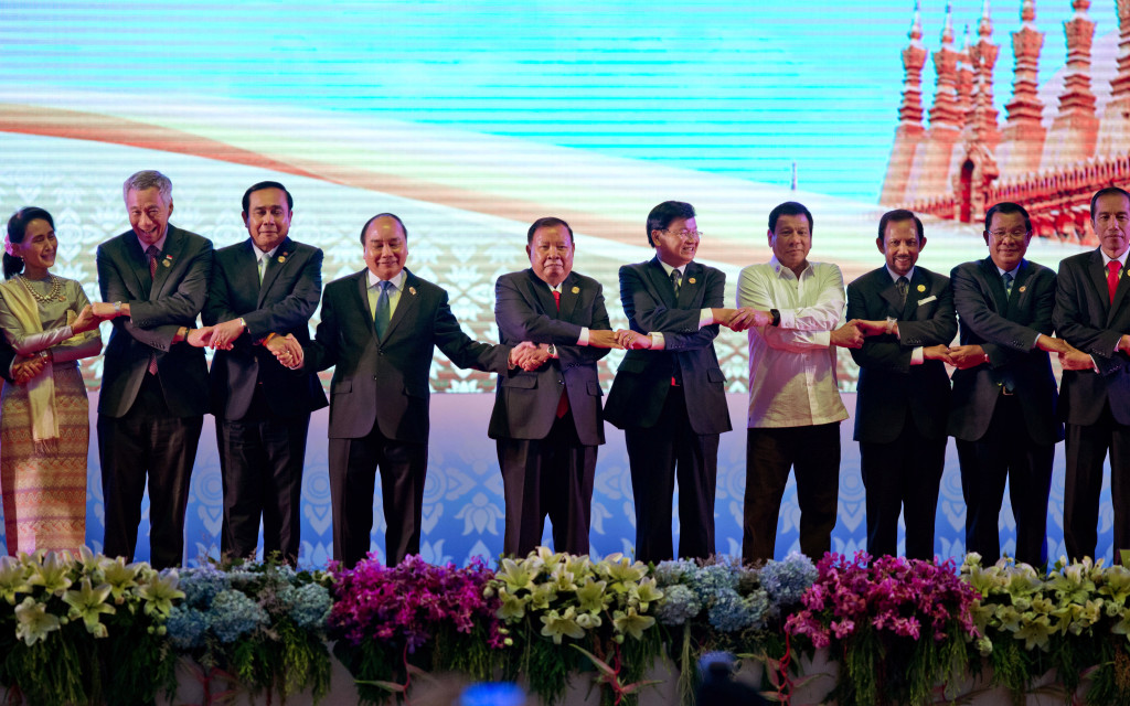 Leaders of the Association of Southeast Asian Nations (ASEAN) from left, Myanmar's State Counsellor and Foreign Minister Aung San Suu Kyi, Singapore's Prime Minister Lee Hsien Loong, Thai Prime Minister Prayuth Chan-ocha, Vietnam's President Tran Dai Quang, Laos President Bounnhang Vorachit, Laos Prime Minister Thongloun Sisoulith, Philippine's President Rodrigo Duterte, Brunei Foreign Minister and Prime Minister Sultan Hassanal Bolkiah, Cambodian Prime Minister Hun Sen and Indonesia's President Joko Widodo hold hands posing for group photo during the opening ceremony of the 28th and 29th ASEAN summits at National Convention Center in Vientiane, Laos, Tuesday, Sept. 6, 2016. (AP Photo/Gemunu Amarasinghe)