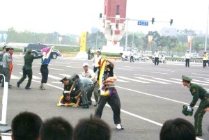 Mendoza while being held down by the Chinese Authority during the Free Tibet protest an hour before the star of the Beijing Olympics on August 8, 2008