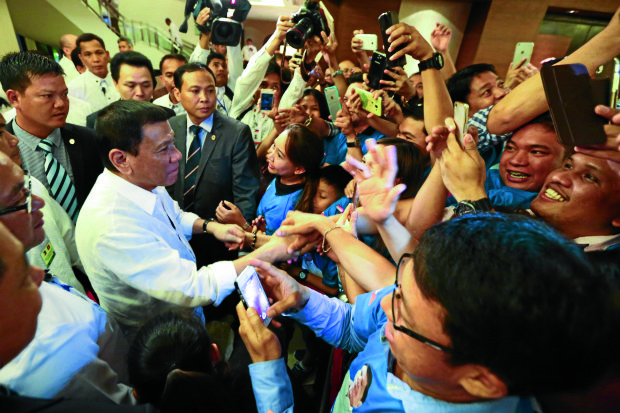 MOBBED President Duterte is warmly received by Filipinos working in Vietnam at the Intercontinental Hotel in Hanoi during his visit to that country onWednesday. MALACAÑANG PHOTO