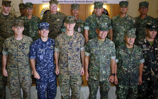U.S. Marines Brig. Gen. John Jansen, third from left front row, of the 3rd Marine Expeditionary Brigade and Maj. Gen. Andre Costales, third from right front row,  Commandant of the Philippine Marines Corps, pose with other military officers following the opening ceremony for the 33rd joint U.S.-Philippines amphibious landing exercises dubbed PHIBLEX at the marines corps in suburban Taguig city, east of Manila, Philippines Tuesday Oct. 4, 2016. President Rodrigo Duterte said he was giving notice to the United States, his country's long-standing ally, that joint exercises between Filipino and American troops this week will be the last such drills. He told the Filipino community in Hanoi, Vietnam’s capital, last week that he will maintain the military alliance with the U.S. because of the countries' 1951 defense treaty. But he said this week's exercises will proceed only because he did not want to embarrass his defense secretary. (AP Photo/Bullit Marquez)