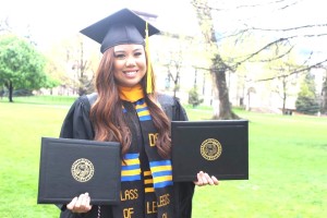 Monica Agsam showing off her two diplomas