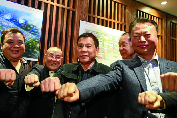 President Rodrigo Duterte along with Chinese Ambassador to the Philippines Zhiao Jianhua and officials of the Friends of the Philippines Foundation poses for a photo at Dadong Roast Duck Restaurant in Beijing, China on October 19. KING RODRIGUEZ/Presidential Photo