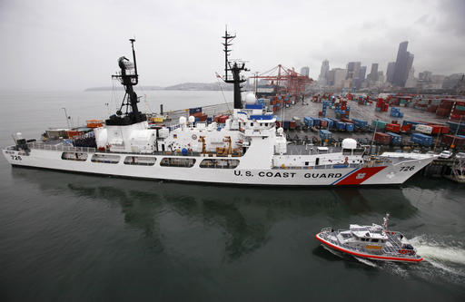 FILE - In this May 25, 2011, file photo, a small U.S. Coast Guard boat passes the USCG Cutter Midgett, docked near downtown Seattle, Washington. The U.S. Coast Guard wants to play a bigger role in patrolling the disputed waters of the South China Sea, mirroring the role China’s coast guard plays in protecting its territorial claims. (AP Photo/Elaine Thompson, File)
