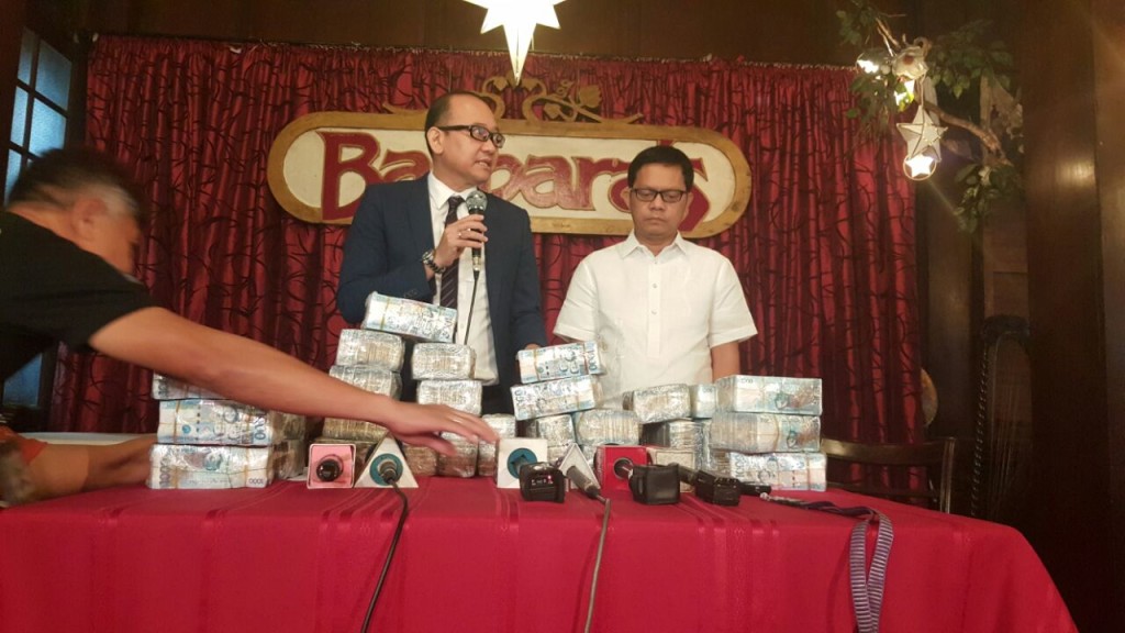 BI Commissioners Al C. Argosino and Michael Robles show to media a copy of their graft complaint against foreign gambling investor Jack Lam,   BI agent Charles Calima, former police general Wally Sombero and Lam's two interpreters on Dec. 13, 2016. (PHOTO BY JULIE AURELIO/ INQUIRER)