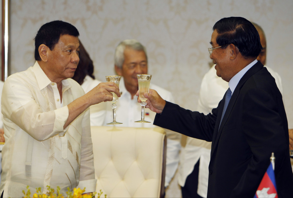 Cambodia's Prime Minister Hun Sen, right, toasts with Philippine President Rodrigo Duterte during a signing ceremony at the Peace Palace, in Phnom Penh, Cambodia, Wednesday, Dec. 14, 2016. Duterte is on a state visit to Cambodia, where a meeting with Prime Minister Hun Sen will bring together two Southeast Asian leaders known for their tough-guy approach to governing. (AP Photo/Heng Sinith)