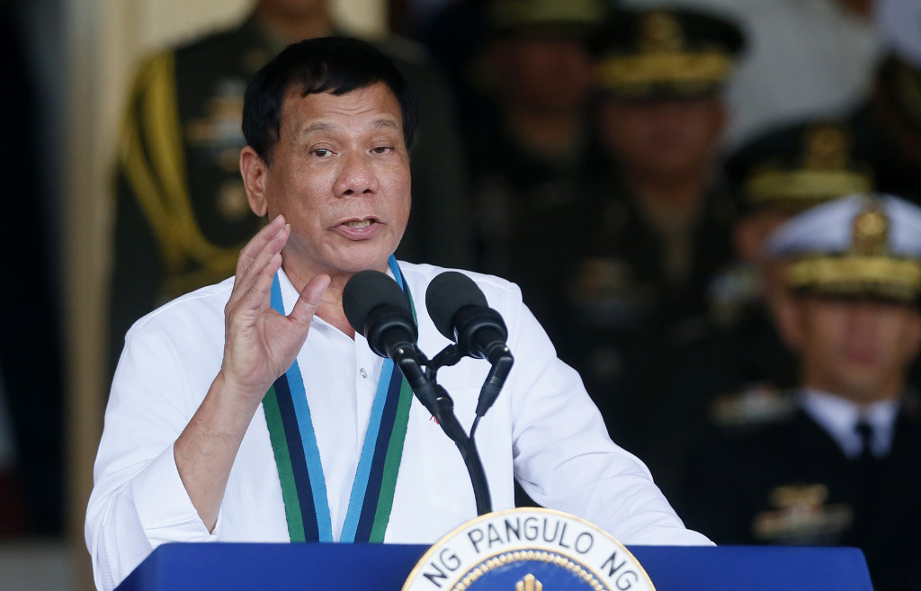 Philippine President Rodrigo Duterte addresses troops during change-of-command ceremony at Camp Aguinaldo in Quezon city, northeast of Manila, Philippines Wednesday, Dec. 7, 2016. Communist rebels warned President Duterte on Wednesday that they may be forced to end their months long cease-fire and resume fighting if he does not suspend the government's counterinsurgency program and withdraw troops from rebel-influenced areas. (AP Photo/Bullit Marquez)