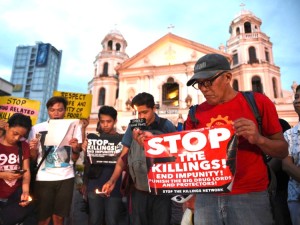 Activists hold a candle light vigil for victims of the extra judicial killings in the drug war of the government in front of a church in Manila on September 16, 2016.  The Philippines faced calls September 16 to investigate its firebrand president after a self-confessed hitman alleged Rodrigo Duterte ordered a thousand opponents and suspected criminals murdered when he was a city mayor. / AFP / TED ALJIBE        (Photo credit should read TED ALJIBE/AFP/Getty Images)
