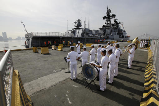 A Philippine Navy Band plays as the Russian Navy vessel Admiral Tributs, a large anti-submarine ship, docks at Manila's pier, Philippines on Tuesday, Jan. 3, 2017. Two Russian Navy Vessels are in the country for a goodwill visit till Jan. 7. (AP Photo/Aaron Favila)