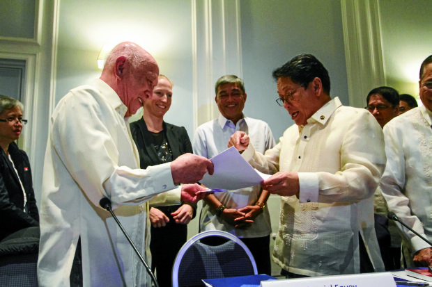 Negotiators of the government and the communist-led National Democratic Front of the Philippines congratulate themselves for a “most successful” round of talks in Rome on Wednesday.—KARLOS MANLUPIG