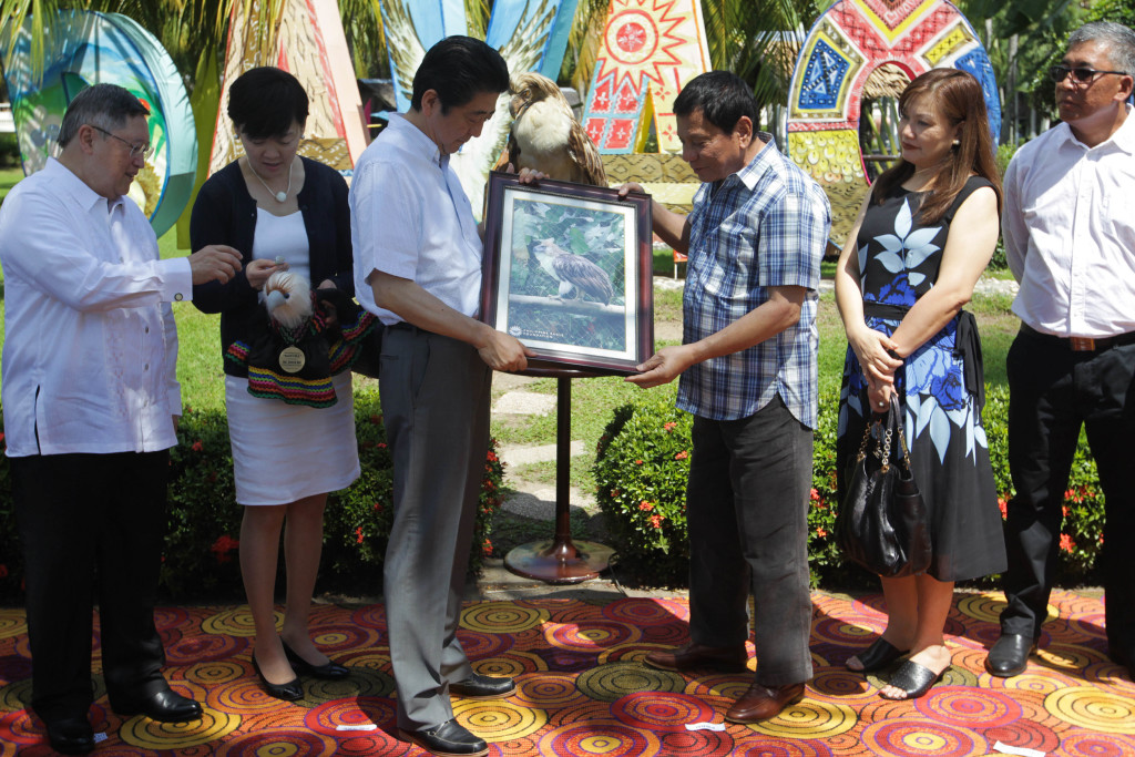 President Rodrigo Roa Duterte gives Japan Prime Minister Shinzo Abe a framed photo of ‘Sakura’, the Philippine Eagle named during a ceremony at Waterfront Hotel in Davao City on January 13, 2017. The name was Japanese-inspired after the Prime Minister of Japan provided support to the Philippine Eagle Foundation, the organization that takes care of the endangered species.  SIMEON CELI JR./Presidential Photo