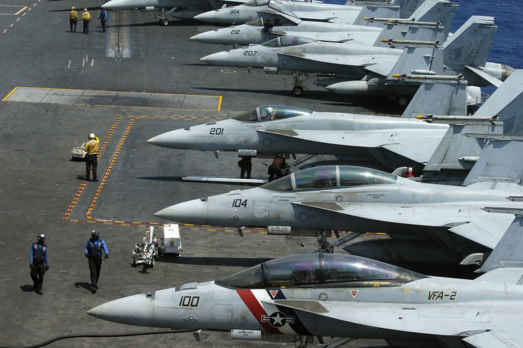 A row of F18 fighter jets on the deck of the U.S. Navy aircraft carrier USS Carl Vinson (CVN 70) is prepared for patrols off the disputed South China Sea Friday, March 3, 2017. AP