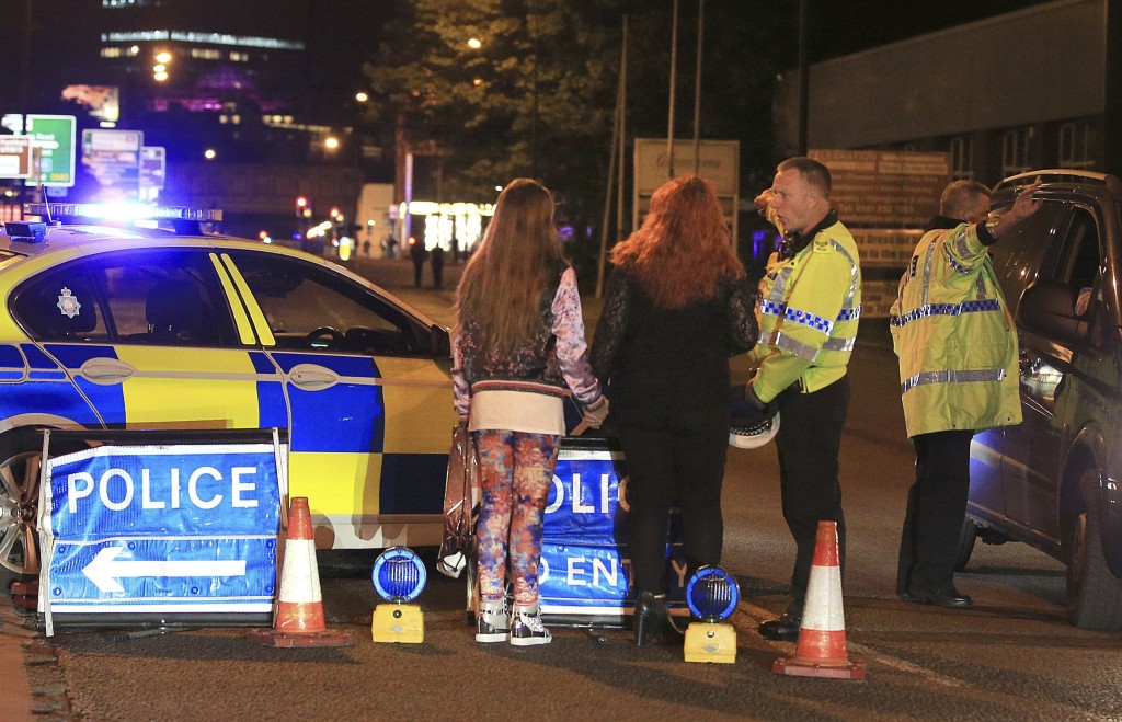Police work at Manchester Arena after reports of an explosion at the venue during an Ariana Grande gig in Manchester, England Monday, May 22, 2017. Several people have died following reports of an explosion Monday night at an Ariana Grande concert in northern England, police said. A representative said the singer was not injured. (Peter Byrne/PA via AP)