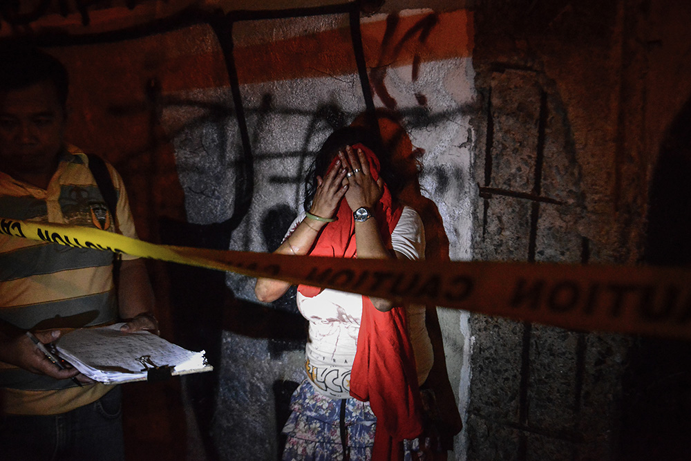 FILE - Diana Vinculado weeps after finding the body of her husband Antonio Vinculado, after he was killed by police in what they say was a shootout with police, in Paranaque, Metro Manila, Philippines, July 14, 2017. The United States congress is the latest to express concern over human rights violations in President Rodrigo Duterte's war on drugs. The Philippine National Police has claimed that there have been at least 12,000 killings throughout the country in the past year, 3,000 of which were drug suspects shot dead in police operations. Another 2,000 killings have been confirmed by police to be drug-related while the other 7,000 deaths are still under investigation. Human rights groups have said that many of these killings were carried out by undercover police or state sanctioned death squads. United Nations member states called on the Philippine government to conduct a "thorough" investigation into extrajudicial killings in the country and hold accountable the perpetrators. Duterte won the presidency a year ago by pledging to kill thousands in an all-out war against drugs in a country where drugs and crime are deeply-rooted.