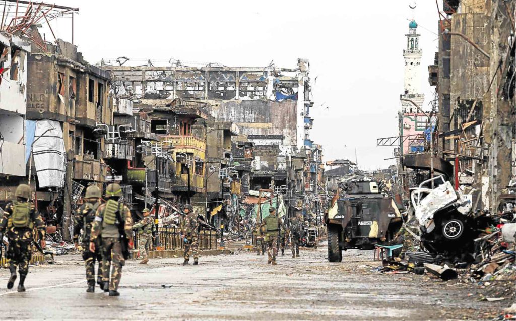 Destruction greeted soldiers as they patrol Bangolo district in Marawi after President Duterte declared the city free  from influence of terrorists. —JEOFFREY MAITEM