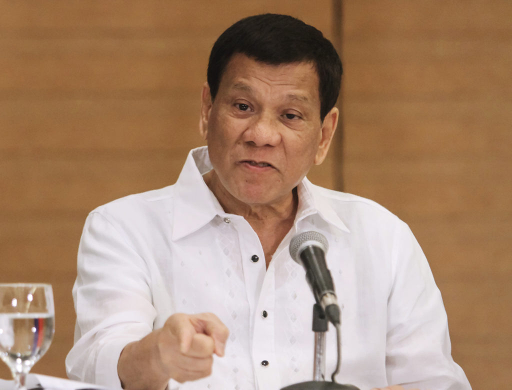Philippine President Rodrigo Duterte gestures as he speaks during a press conference in Davao City, in the southern island of Mindanao on February 9, 2018. Duterte on February 9, declared himself beyond the jurisdiction of an International Criminal Court probe into thousands of deaths in his "drugs war", claiming local laws do not specifically ban extrajudicial killings. / AFP PHOTO / -