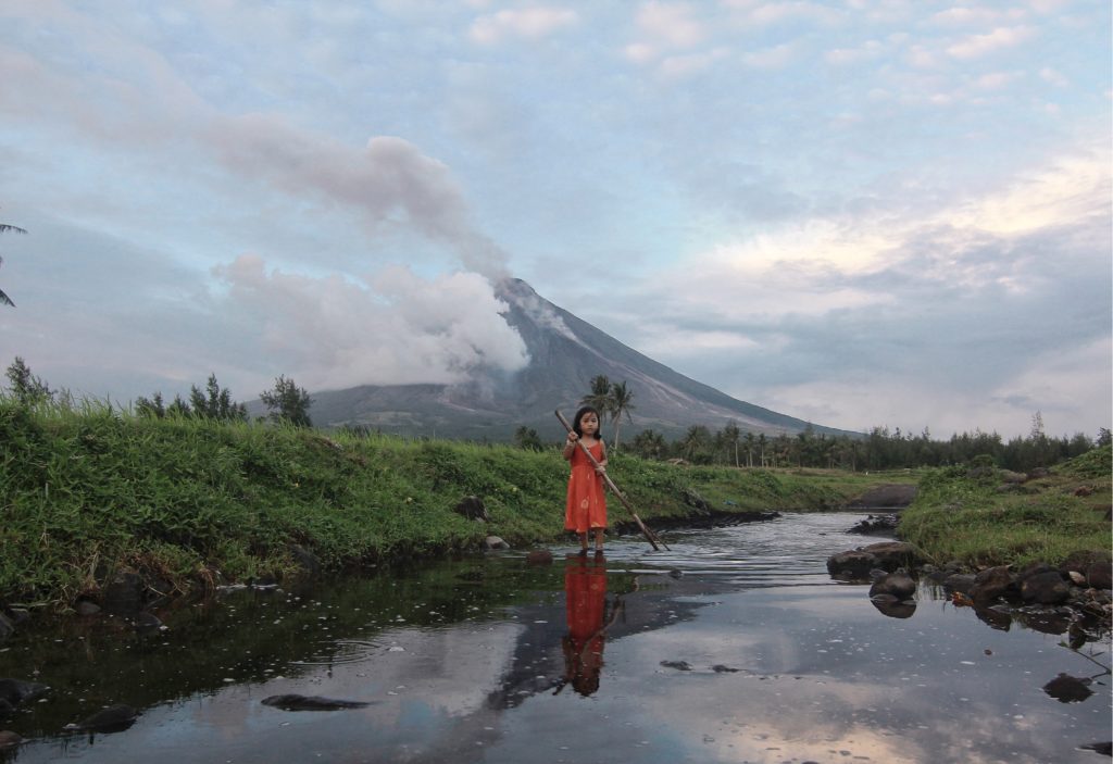 MAYON / FEBRUARY 6, 2018 A child plays in the river in Barangay Busay, Daraga, Albay, with Mayon Volcano in the background. Mayon Volcano has been showing signs of restiveness since the middle of January. Alert level 4 is still raised over the volcano and the public is advised not to venture into the eight-kilometer danger zone. INQUIRER PHOTO/GEORGE GIO BRONDIAL/INQUIRER SOUTHERN LUZON