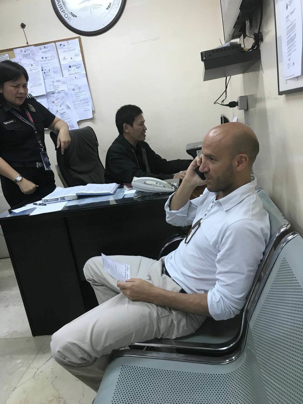Giacomo Filibeck, deputy secretary-general of the Party of European Socialists, talks to someone on his cellular phone while he was held by immigration officers at the Mactan Cebu International Airport on Sunday. He was subsequently deported for participating in illegal political activities./CONTRIBUTED PHOTO/AKBAYAN
