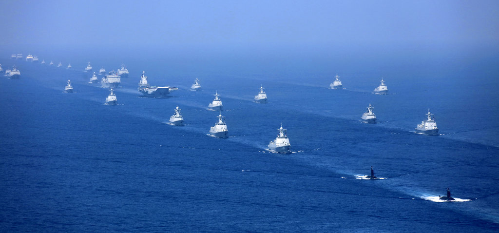 In this April 12, 2018 photo released by Xinhua News Agency, the Liaoning aircraft carrier is accompanied by navy frigates and submarines conducting an exercises in the South China Sea. China has announced live-fire military exercises in the Taiwan Strait amid heightened tensions over increased American support for Taiwan. The announcement by authorities in the coastal province of Fujian on Thursday was accompanied by a statement that the navy was ending a three-day exercise in the South China one day early. (Li Gang/Xinhua via AP)