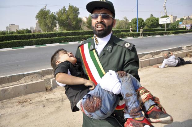 Iranian soldier carrying child