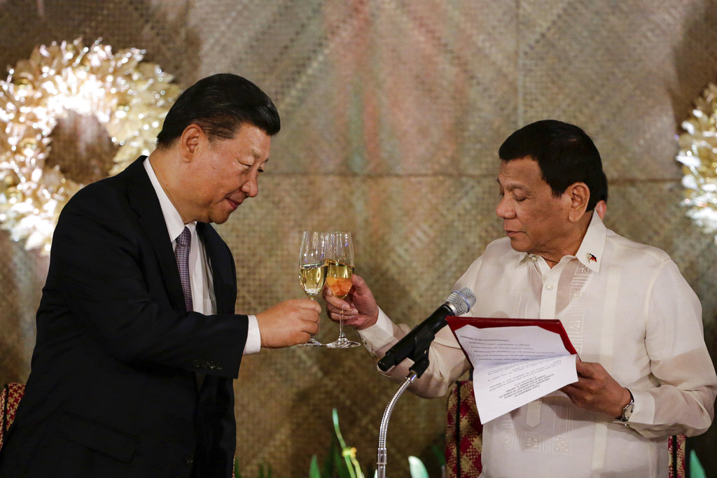 Philippine President Rodrigo Duterte, right, proposes a toast to Chinese President Xi Jinping during a state banquet at Malacanang Palace in Manila, Philippines, Tuesday, Nov. 20, 2018. President Xi Jinping is on a two-day state visit, the first by a Chinese leader in 13 years. (Mark R. Cristino, Pool Photo via AP)