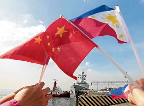 The flags of China and the Philippines STORY: China denies ‘forceful’ retrieval of rocket debris in South China Sea