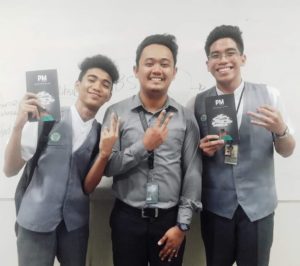 Gerome Dela Pena (middle) with students holding his latest poetry collection (PHOTO BY GEROME DELA PENA)