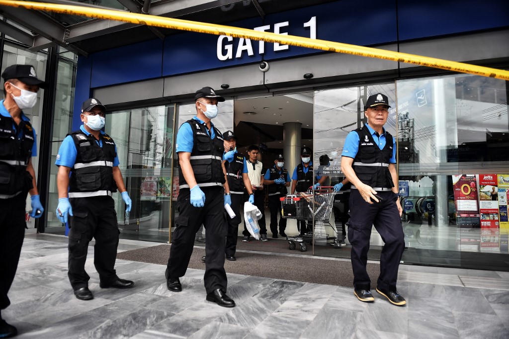 Forensics police leave the Terminal 21 shopping mall, where a mass shooting took place, in the Thai northeastern city of Nakhon Ratchasima on February 10, 2020. - A Thai soldier who killed at least 20 people and holed up in a mall overnight was shot dead by commandos on February 9, ending a near-17-hour ordeal which left dozens wounded and stunned the country. (Photo by Lillian SUWANRUMPHA / AFP)