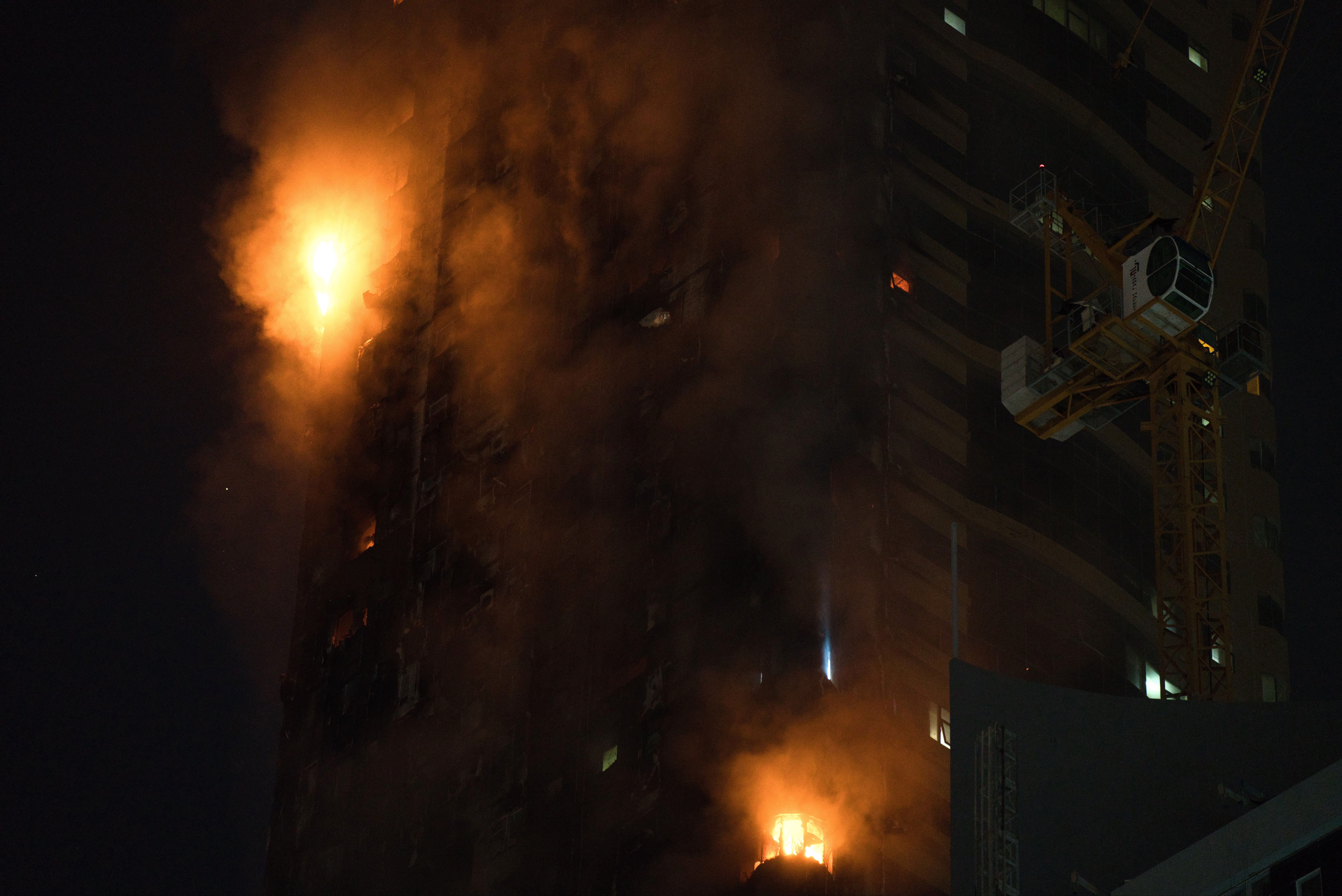 A fire burns on the side of a high-rise building in Sharjah, United Arab Emirates, Tuesday, May 5, 2020. A high-rise tower caught fire Tuesday in the United Arab Emirates and authorities said it wasn't immediately clear what caused the blaze. (AP Photo/Jon Gambrell)
