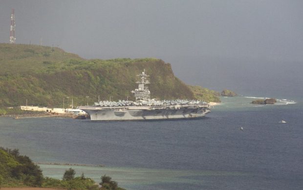 The aircraft carrier USS Theodore Roosevelt, is docked at Naval Base Guam in Apra Harbor amid the coronavirus pandemic on Monday, April 27, 2020. - At least 955 crew members aboard the USS Theodore Roosevelt have tested positive for COVID-19, according to the Navy.