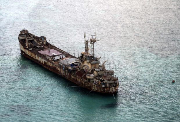 This aerial photograph taken from a military aircraft shows the dilapidated Sierra Madre ship of the Philippine Navy anchored near Ayungin Shoal (Second Thomas Shoal) with Philippine soldiers on board to secure the perimeter in the Spratly group of islands in the South China Sea, west of Palawan, on May 11, 2015.