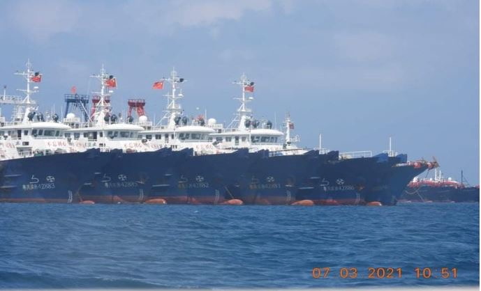 Some of the about 220 vessels reported by the Philippine Coast Guard are pictured at Whitsun Reef, South China Sea