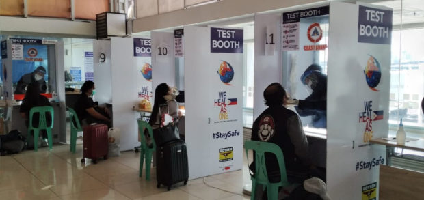 Repatriated overseas Filipino Workers (OFWs) taking their swab tests upon arrival at the airport. Photo from DFA