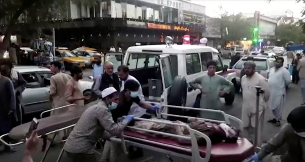A screen grab shows people carrying an injured person to a hospital after an attack at Kabul airport, in Kabul, Afghanistan August 26, 2021. 