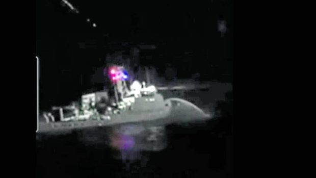 NIGHT ATTACK A blurry image from a cell phone camera of one of the crew members of a Filipino boat shows the Chinese Coast Guard ship that blasted them with a water cannon on Tuesday night to prevent them from bringing supplies to troops on the rusted BRP Sierra Madre, which serves as a Philippine outpost at Ayungin (Second Thomas) Shoal west of Palawan province. No one was injured in the attack. —VIDEO GRAB