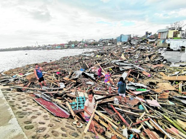FILE PHOTO: Residents of Ubay, Bohol, dig through piles of debris to find anything they can use to rebuild their homes destroyed by Typhoon Odette (international name: Rai), as it battered the Visayas and Mindanao regions in mid-December 2021. Leo Udtohan